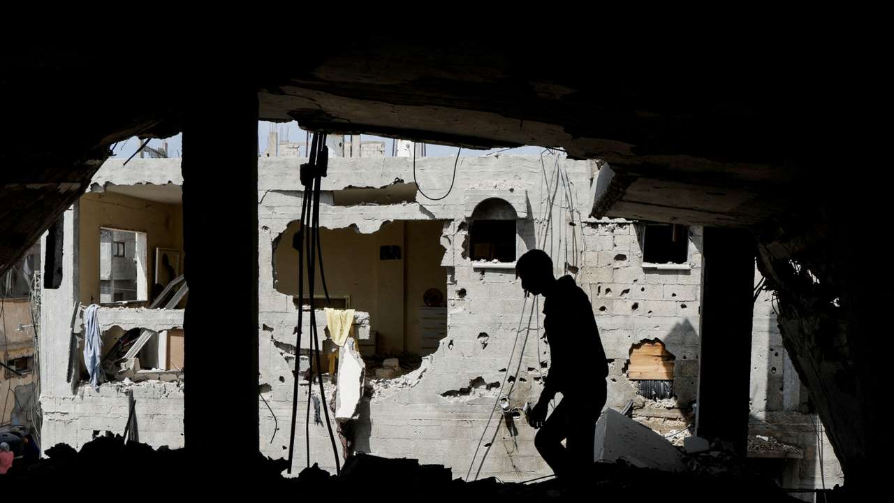 FILE PHOTO: Palestinian man inspects the house where Palestinian newlywed Hala Zaarab was killed in an Israeli airstrike, in Khan Younis
