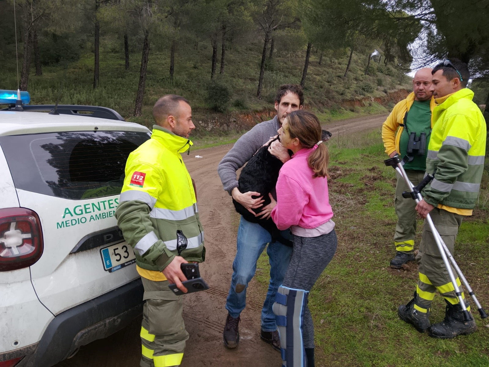 Ana Garcia Aranda hugs her dog 'Boro' after it was rescued by Andalusia regional firefighters days after the deadly derailment of two high-speed trains, in Adamuz