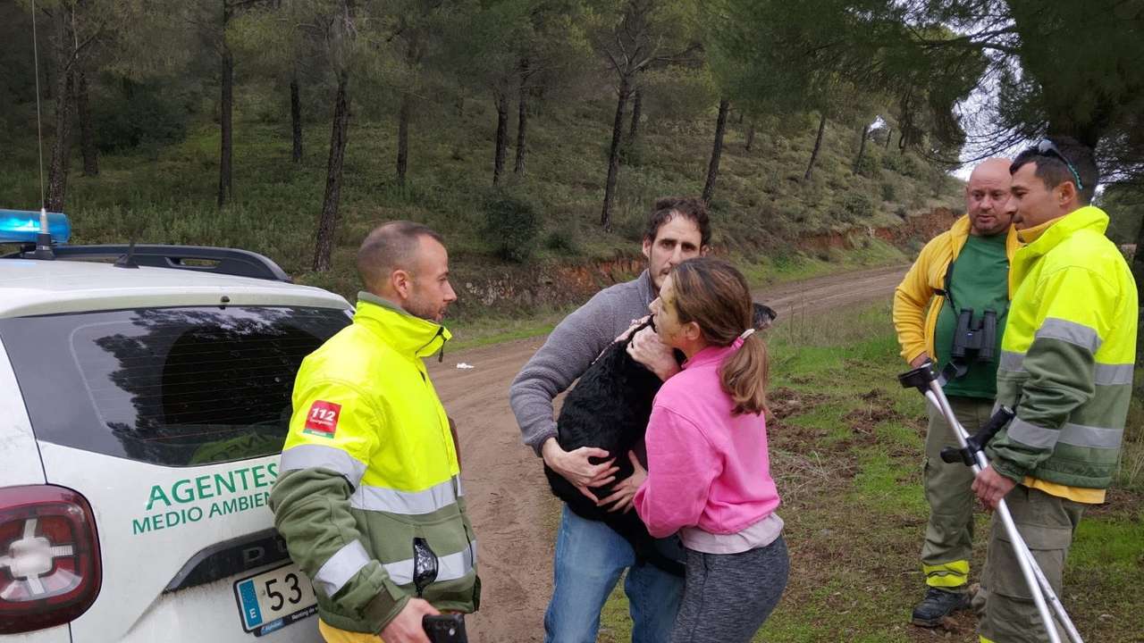 Ana Garcia Aranda hugs her dog 'Boro' after it was rescued by Andalusia regional firefighters days after the deadly derailment of two high-speed trains, in Adamuz