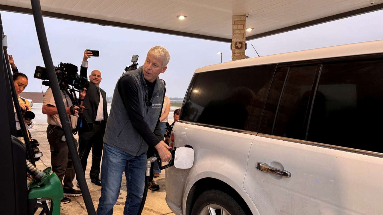 FILE PHOTO: U.S. Energy Secretary Chris Wright pumps gas and speaks with customers at a gas station in Corpus Christi, Texas