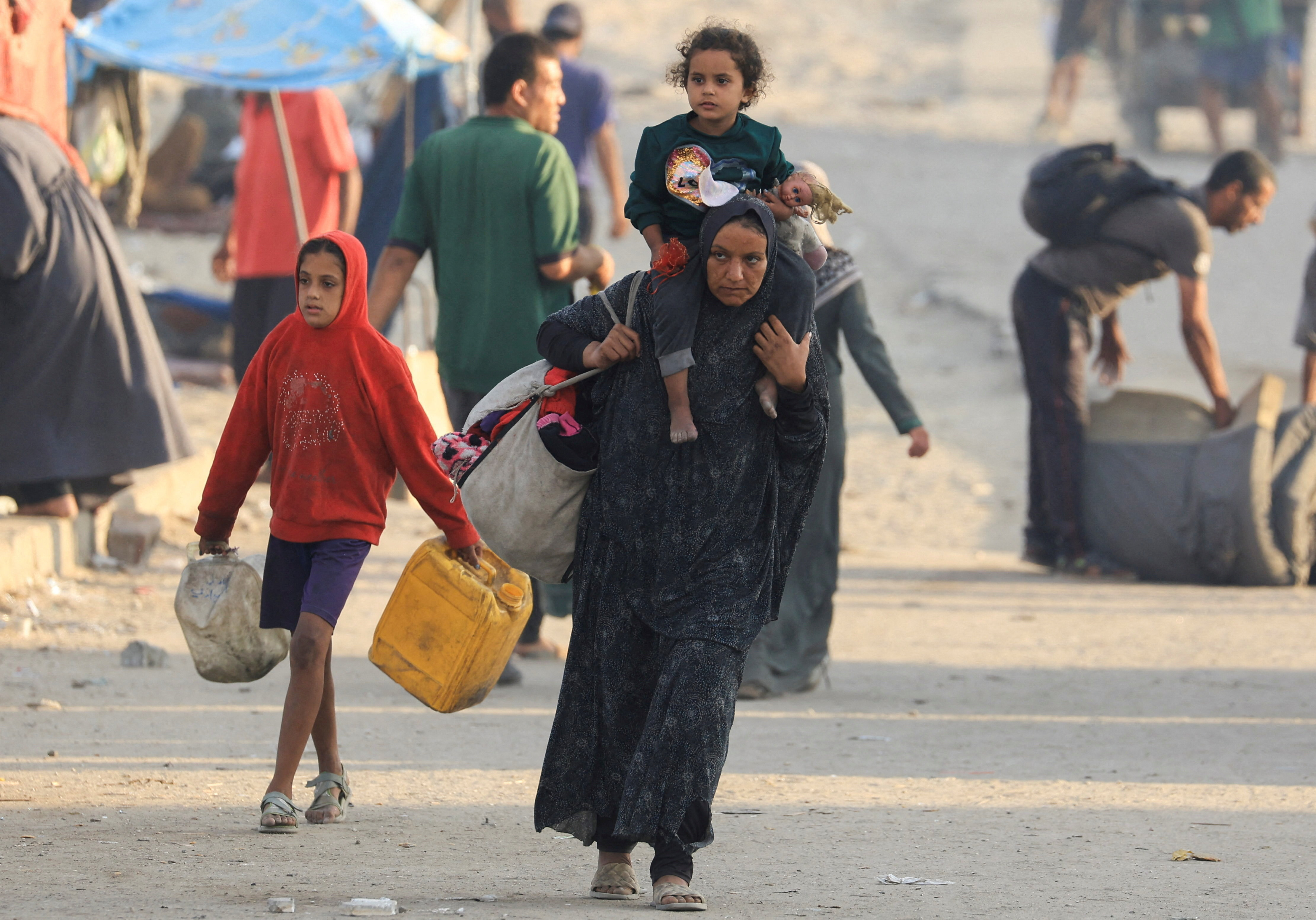Displaced Palestinians, fleeing northern Gaza due to an Israeli military operation, move southward, in the central Gaza Strip