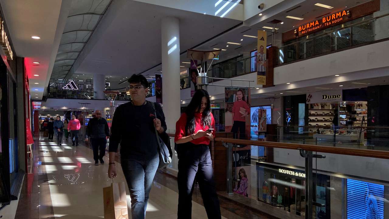 Shoppers walk inside a shopping mall in New Delhi