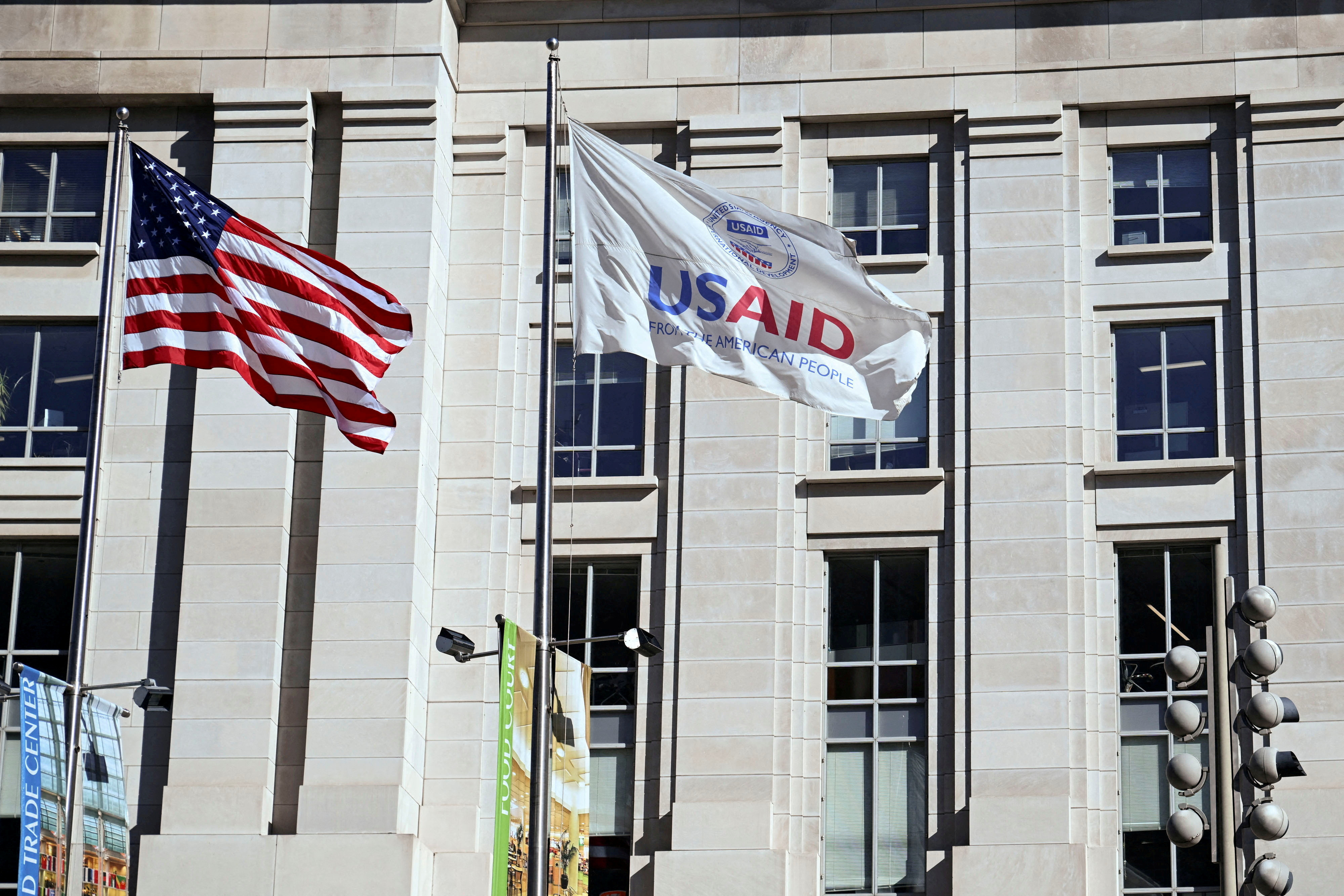 FILE PHOTO: FILE PHOTO: An American flag and USAID flag fly outside the USAID building in Washington