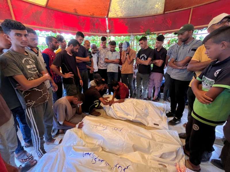 Mourners react as they gather around the bodies of Palestinians killed in Israeli strikes, amid Israel-Hamas conflict, at Nasser hospital in Khan Younis in the southern Gaza Strip