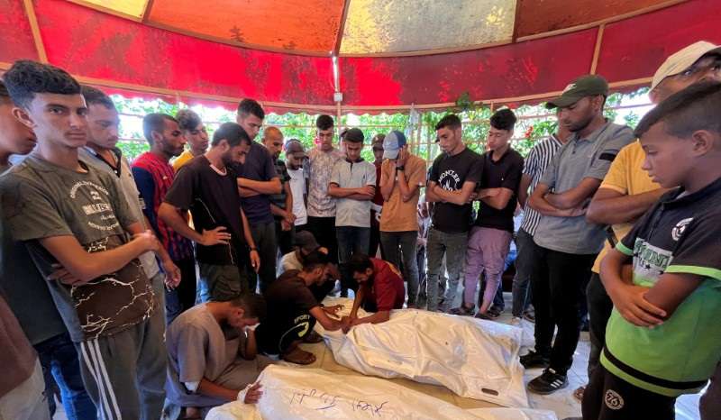 Mourners react as they gather around the bodies of Palestinians killed in Israeli strikes, amid Israel-Hamas conflict, at Nasser hospital in Khan Younis in the southern Gaza Strip