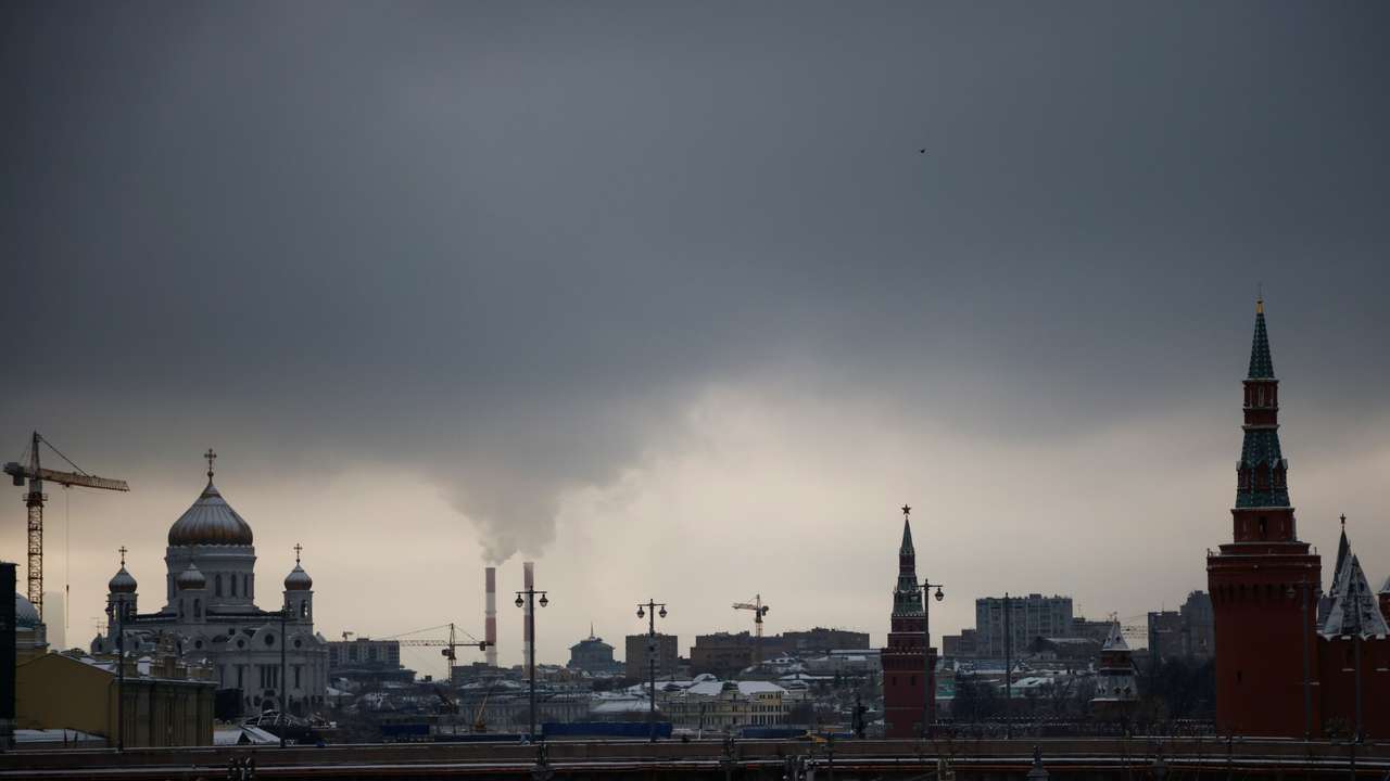 Steam rises from chimneys of a heating power plan over the skyline of central Moscow