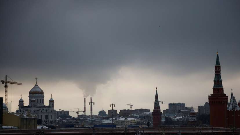 Steam rises from chimneys of a heating power plan over the skyline of central Moscow