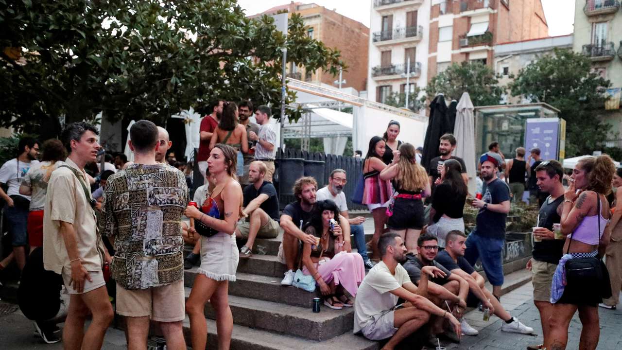 FILE PHOTO: Tourists and residents drink on a street in Gracia neighbourhood during a heatwave of the summer, in Barcelona
