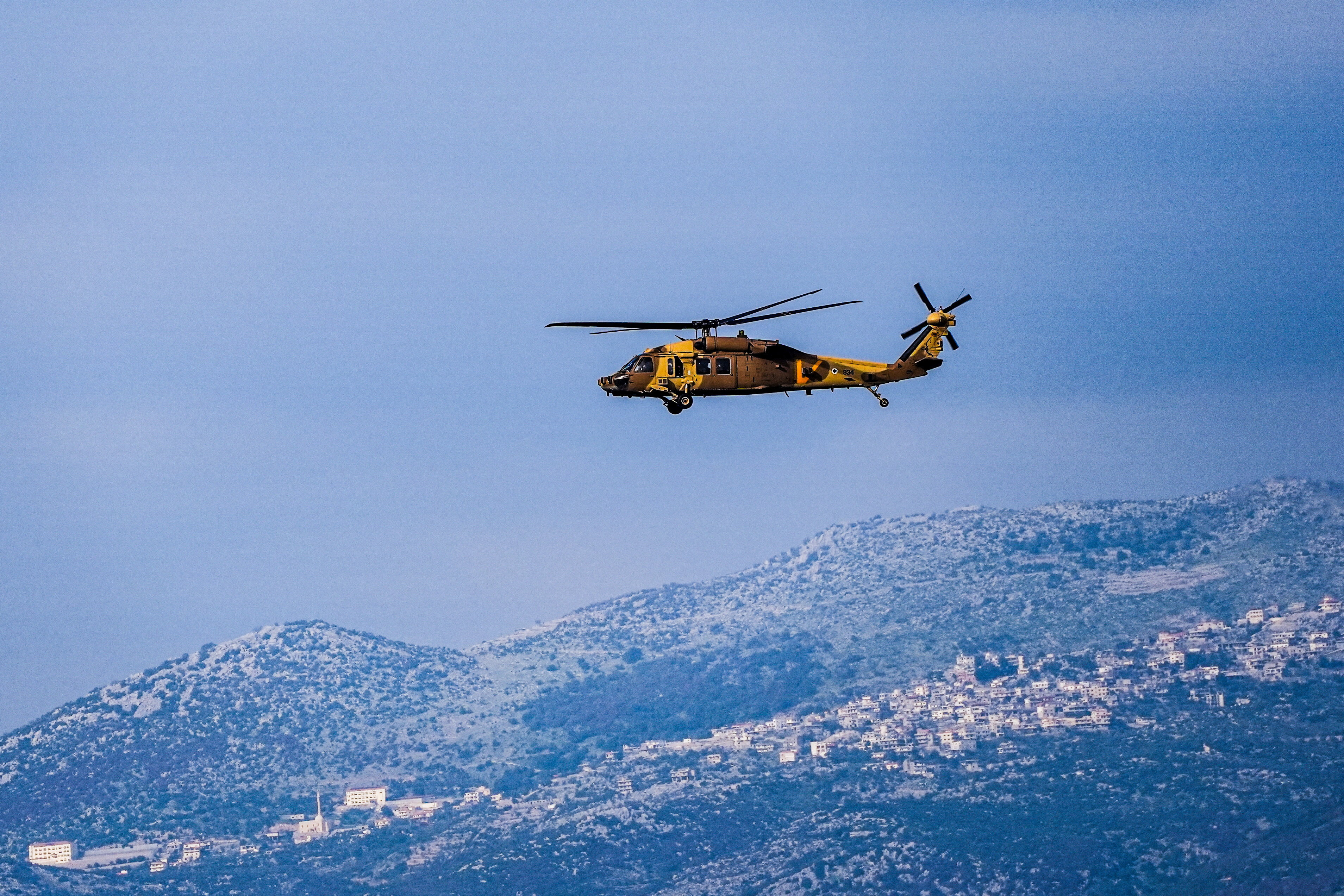 An Israeli military helicopter flies above the border between Israel and Lebanon, amid escalating hostilities between Israel and Hezbollah, as the U.S.-Israeli conflict with Iran continues, in northern Israel