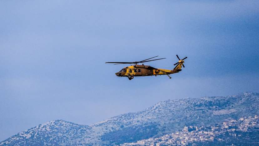 An Israeli military helicopter flies above the border between Israel and Lebanon, amid escalating hostilities between Israel and Hezbollah, as the U.S.-Israeli conflict with Iran continues, in northern Israel