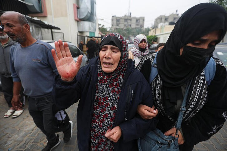 Bodies of Palestinians who were killed during Israeli strikes are laid out at Nasser hospital
