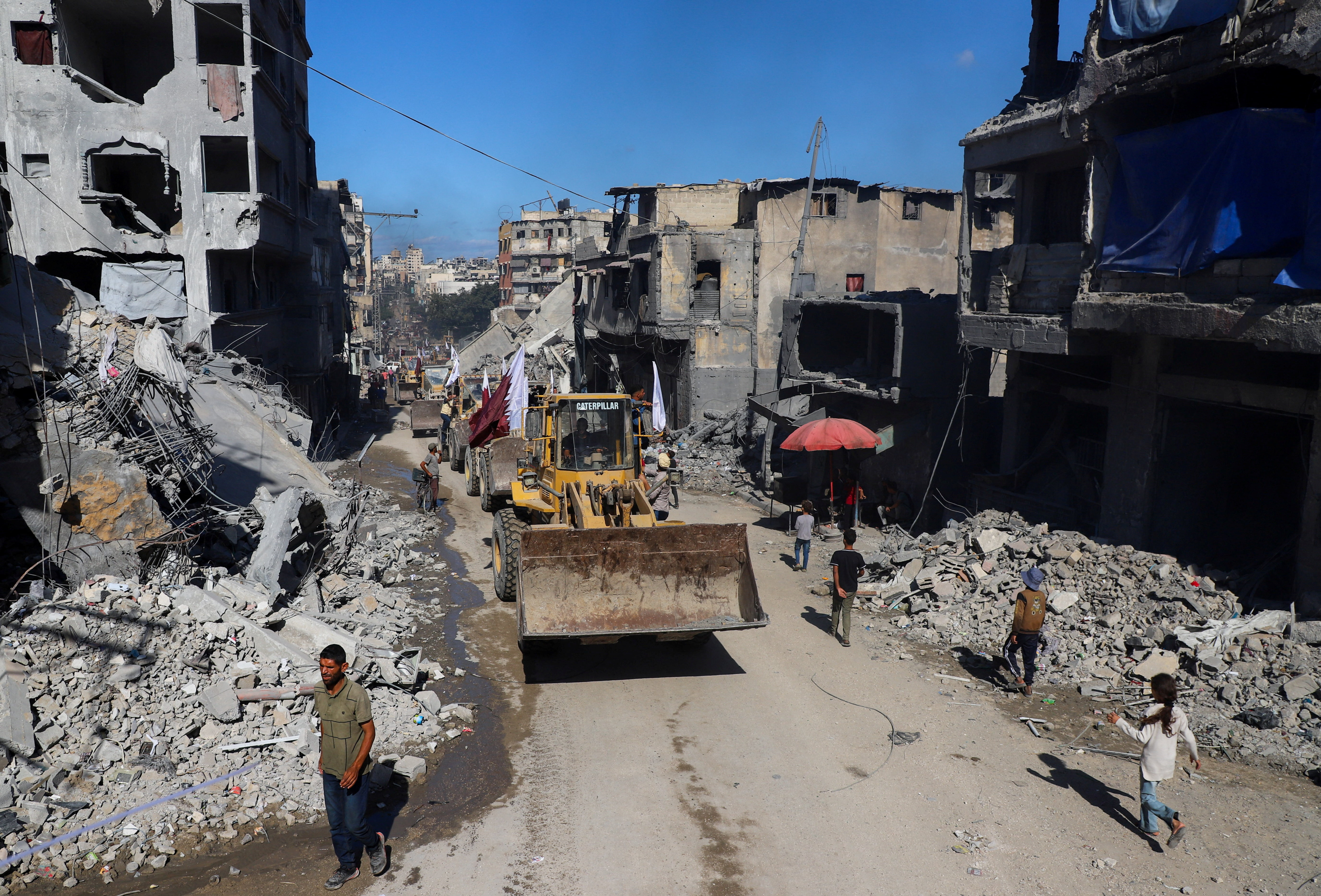 Heavy machinery drives through a street,amid a ceasefire between Israel and Hamas, in Gaza City