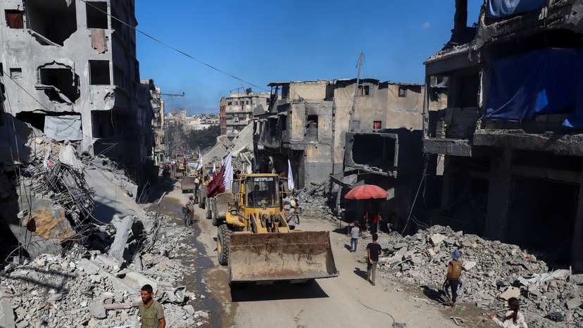 Heavy machinery drives through a street,amid a ceasefire between Israel and Hamas, in Gaza City