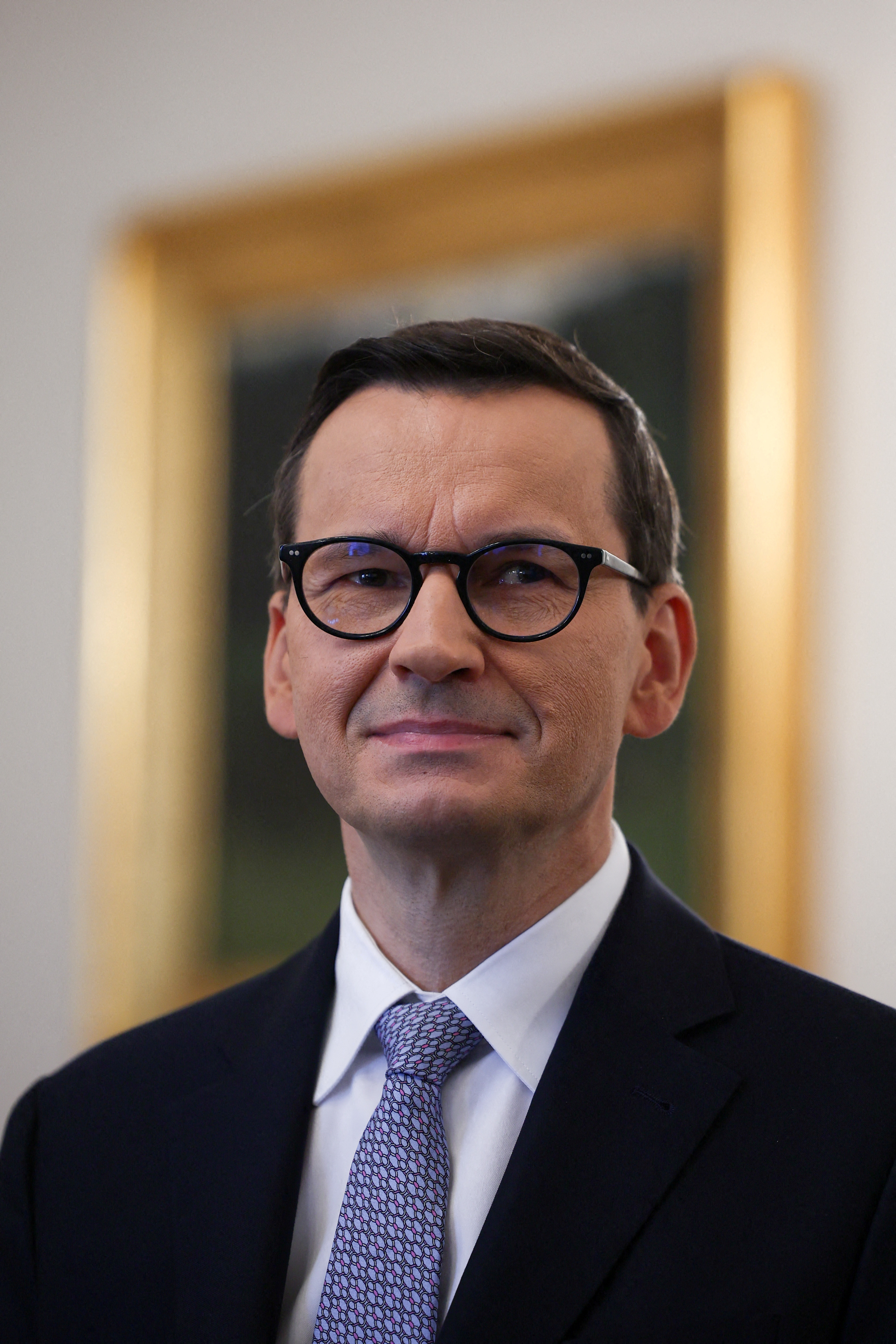FILE PHOTO: Polish Prime Minister Mateusz Morawiecki from Law and Justice party looks on before presidential consultations with the leaders of the two main parties in the newly elected parliament - Law and Justice and Civic Platform, in Presidential Palace