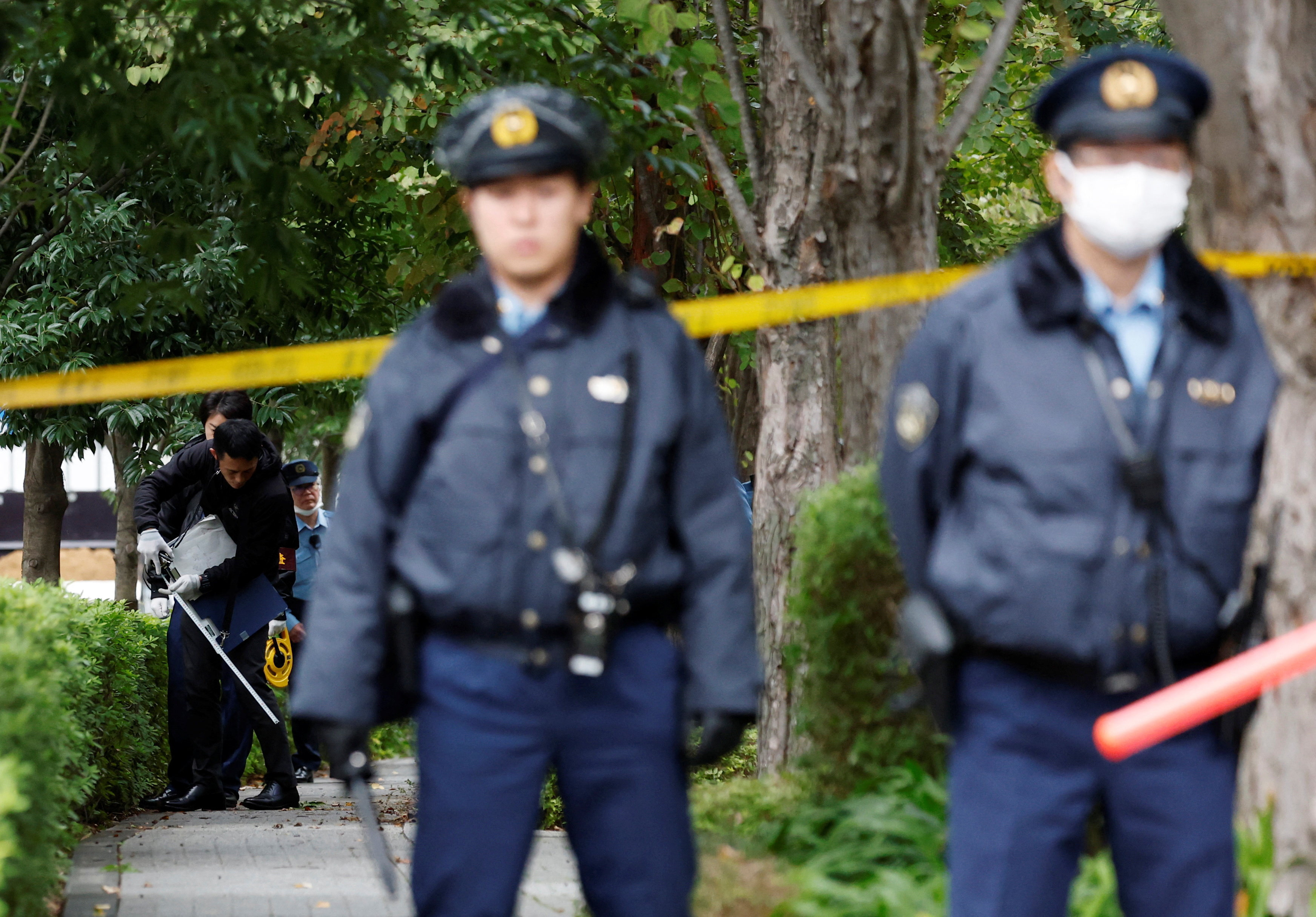Policemen investigate a site where a man wielding a knife was arrested, near the U.S. embassy in Tokyo