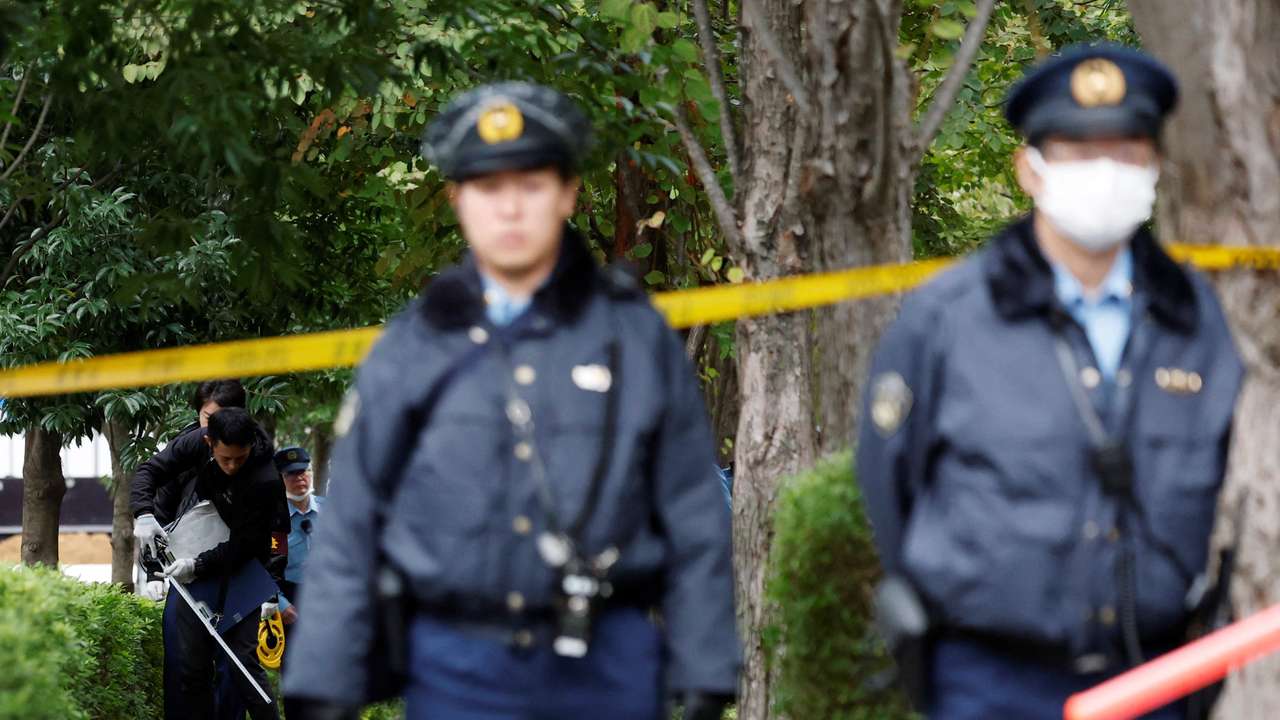 Policemen investigate a site where a man wielding a knife was arrested, near the U.S. embassy in Tokyo