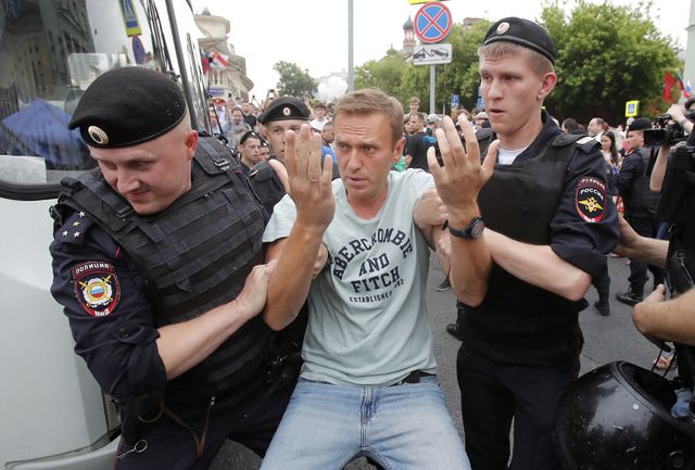 FILE PHOTO: Policemen detain Russian opposition leader Navalny during a rally in support of investigative journalist Golunov in Moscow