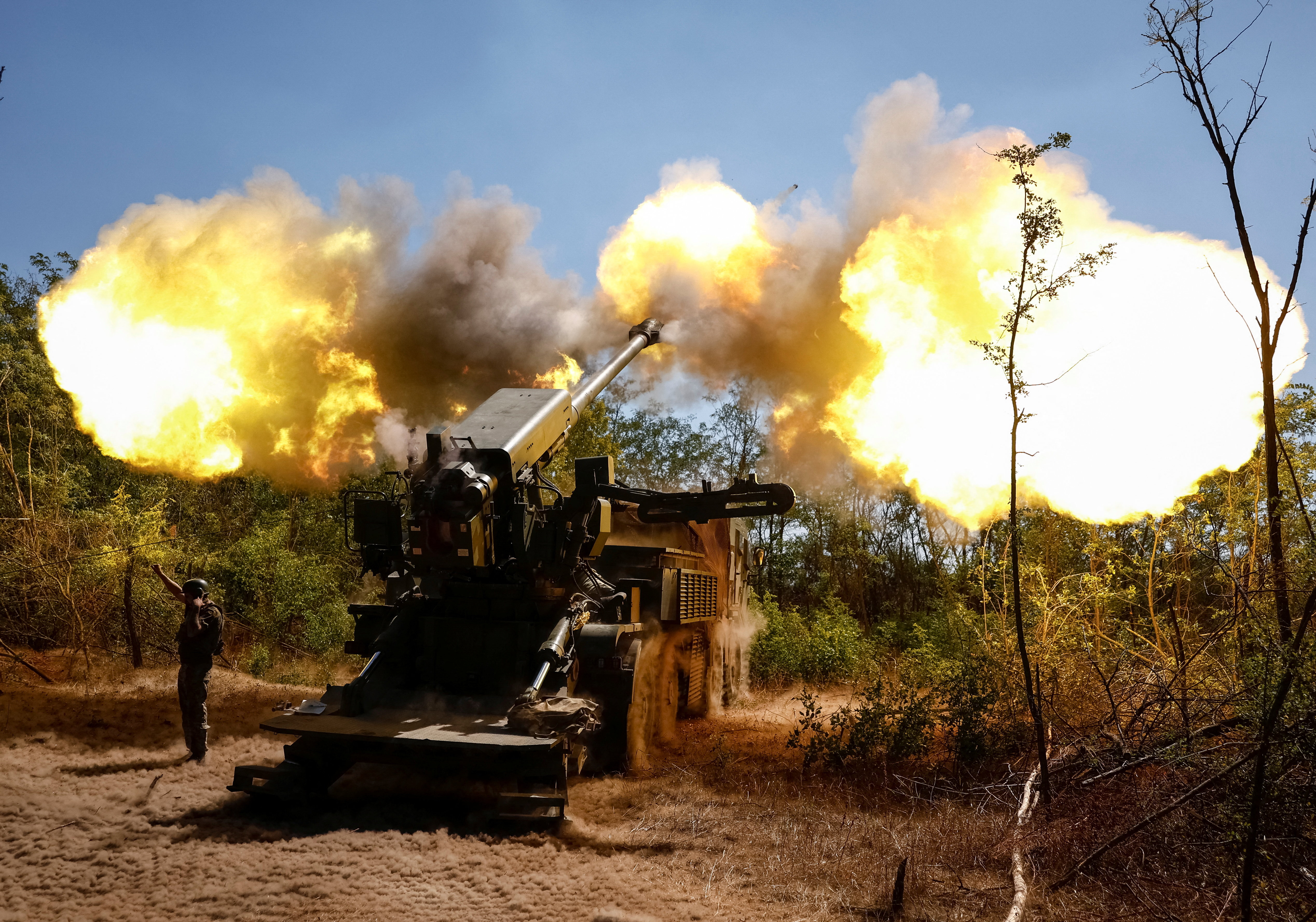 A Ukrainian serviceman fires a self-propelled howitzer towards Russian troops in Zaporizhzhia region