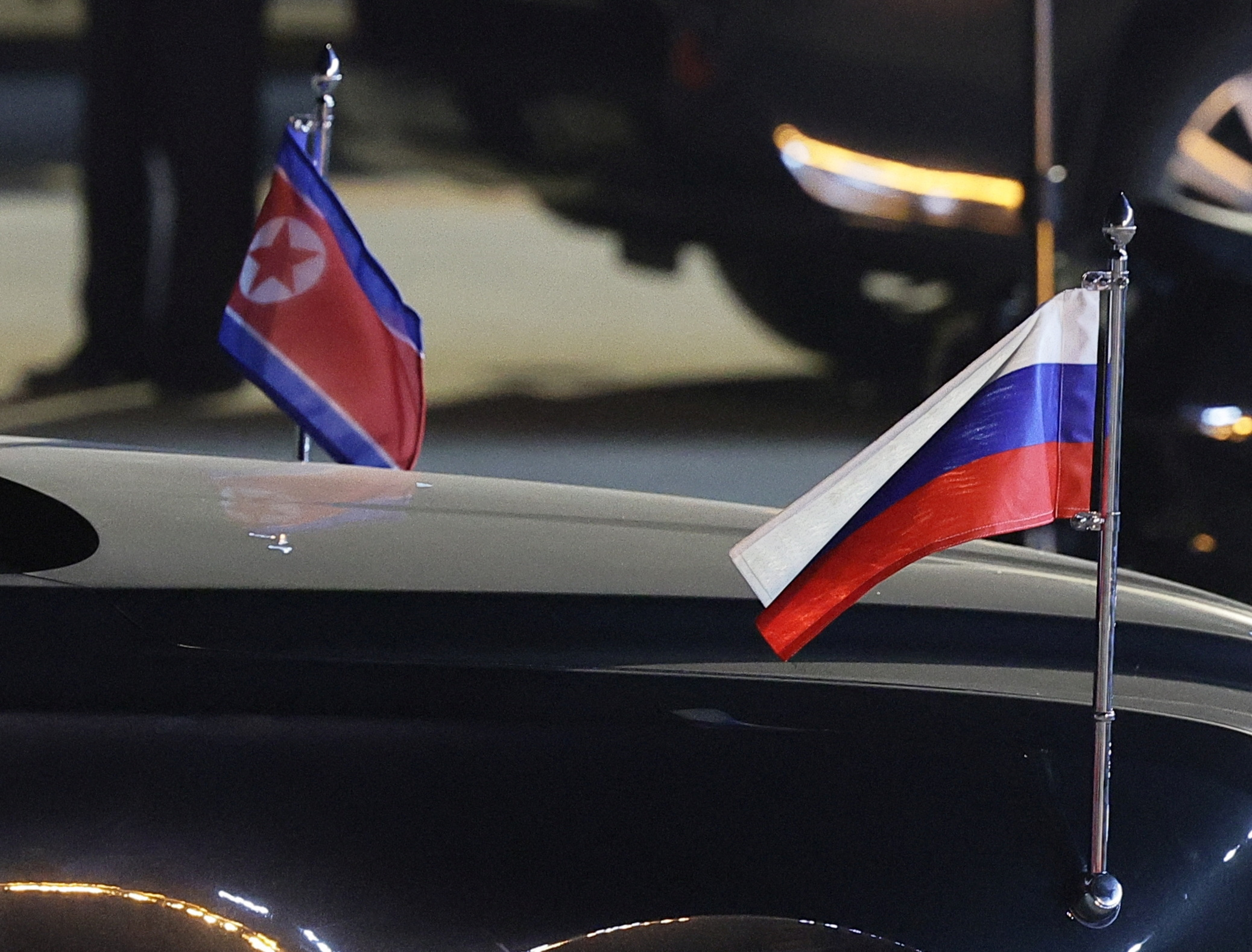 A view shows flags of Russia and North Korea attached to a car during a ceremony welcoming Russia's President Vladimir Putin at an airport in Pyongyang