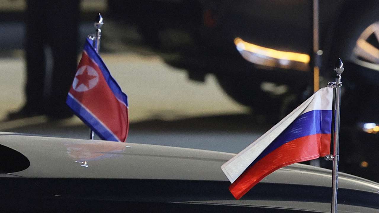 A view shows flags of Russia and North Korea attached to a car during a ceremony welcoming Russia's President Vladimir Putin at an airport in Pyongyang