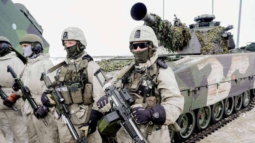 FILE PHOTO: Soldiers stand next to a military vehicle as Norwegian, Swedish and Finnish forces participate in a military exercise, in Kautokeino