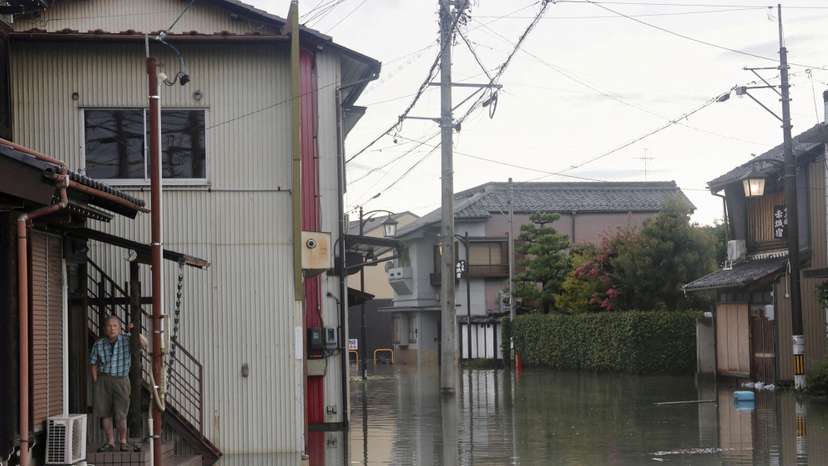 FILE PHOTO: A man stands at a residential area affected by the flooding of the Kuise River caused by Typhoon Shanshan in Ogaki