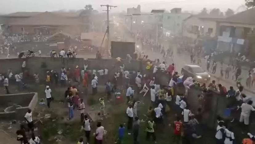 FILE PHOTO: People scramble in Nzerekore where local officials said a crush occurred following clashes at a soccer match