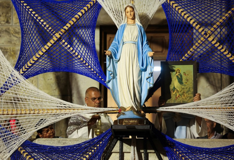 The statue of Virgin Mary is pictured as people celebrate the feast of Assumption of Virgin Mary, at the southern town of Ain Ebel