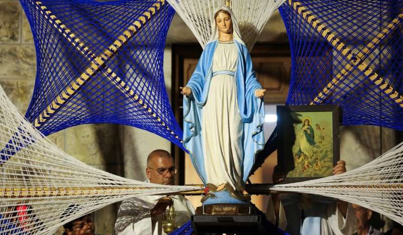 The statue of Virgin Mary is pictured as people celebrate the feast of Assumption of Virgin Mary, at the southern town of Ain Ebel