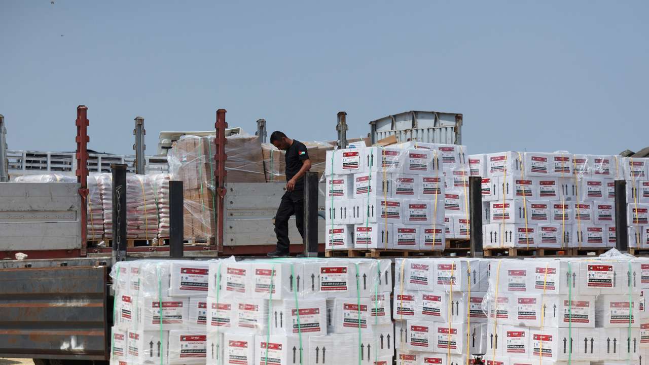 A worker unloads humanitarian aid near Erez Crossing in northern Gaza