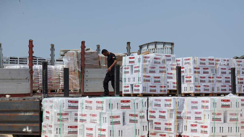 A worker unloads humanitarian aid near Erez Crossing in northern Gaza