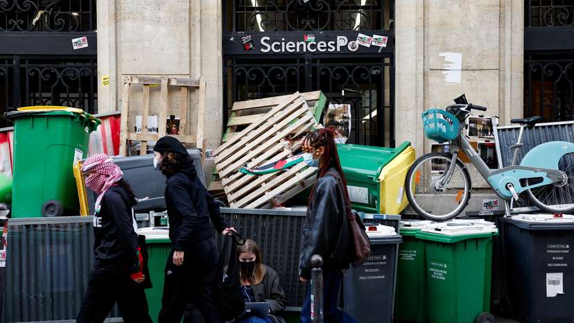 Masked youths take part in the occupation of a building of the Sciences Po University in support of Palestinians in Gaza, in Paris