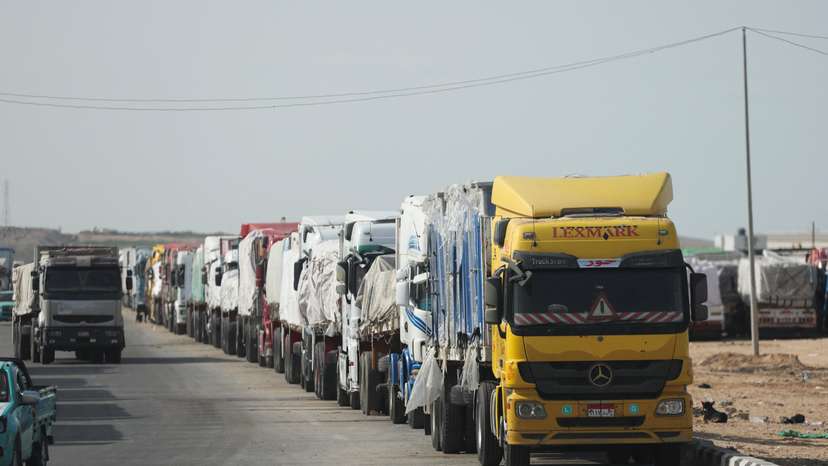 Aid trucks wait near the Rafah border crossing between Egypt and the Gaza Strip