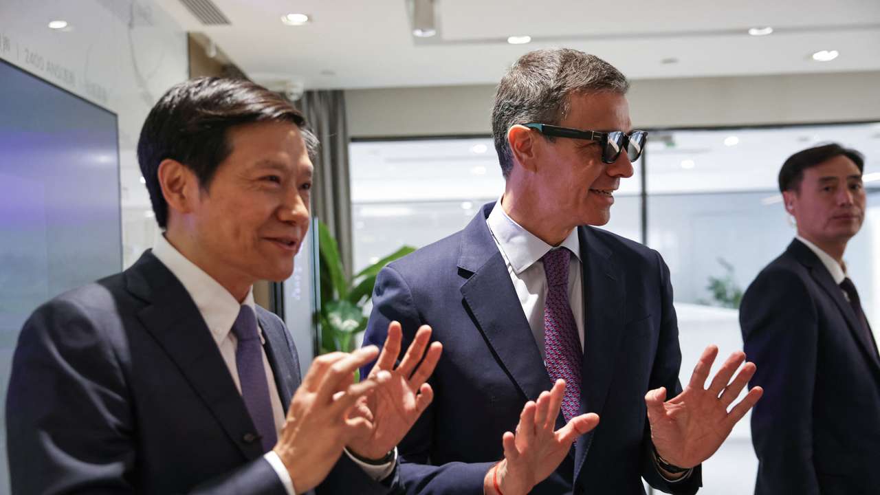 Spain's Prime Minister Pedro Sanchez tries a pair of Xiaomi smart glasses in presence of Founder, Chairman & CEO of Xiaomi, Lei Jun