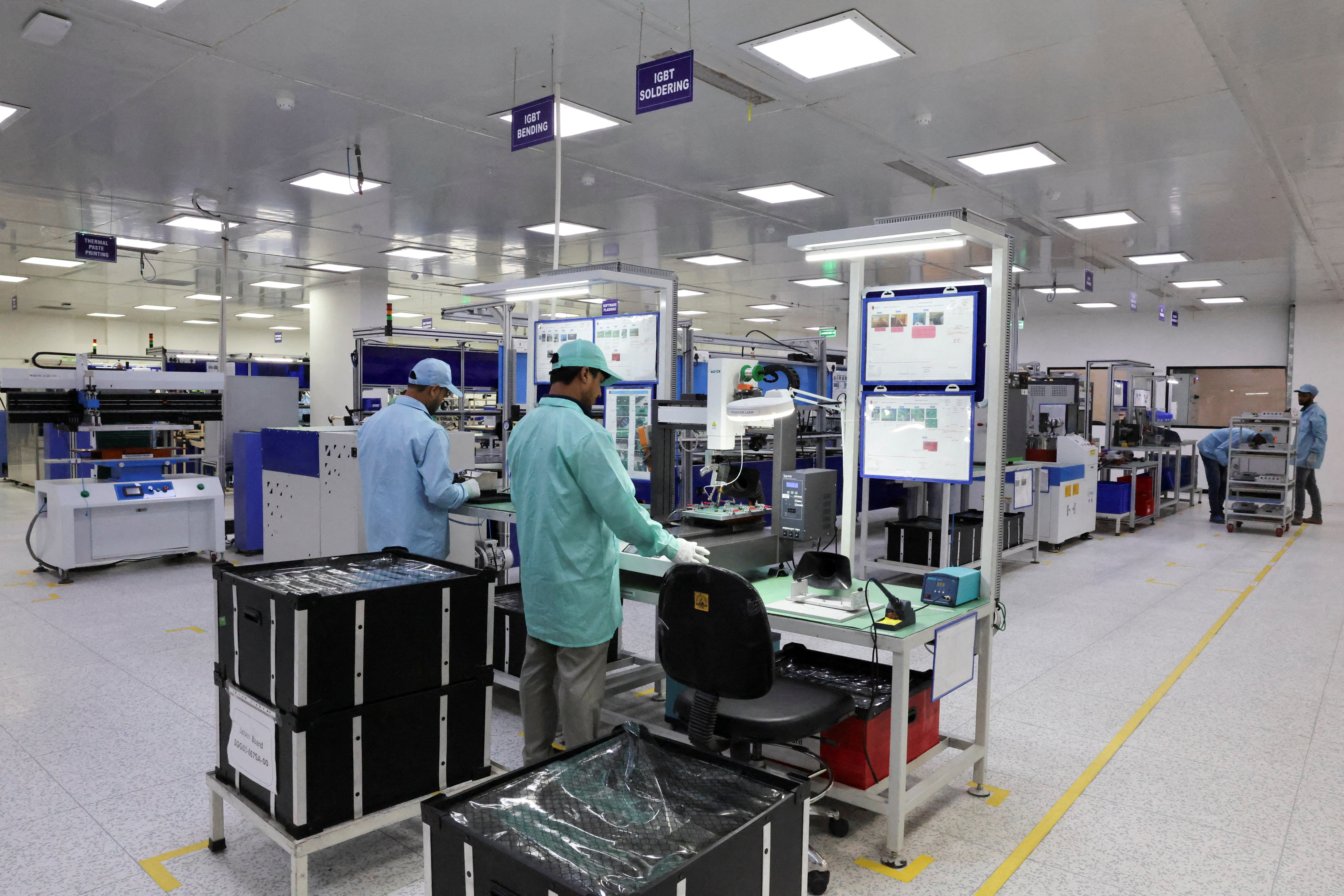 Employees work at Sterling Gtake E-Mobility's factory