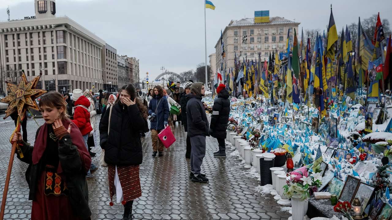 People visit a makeshift memorial in central Kyiv