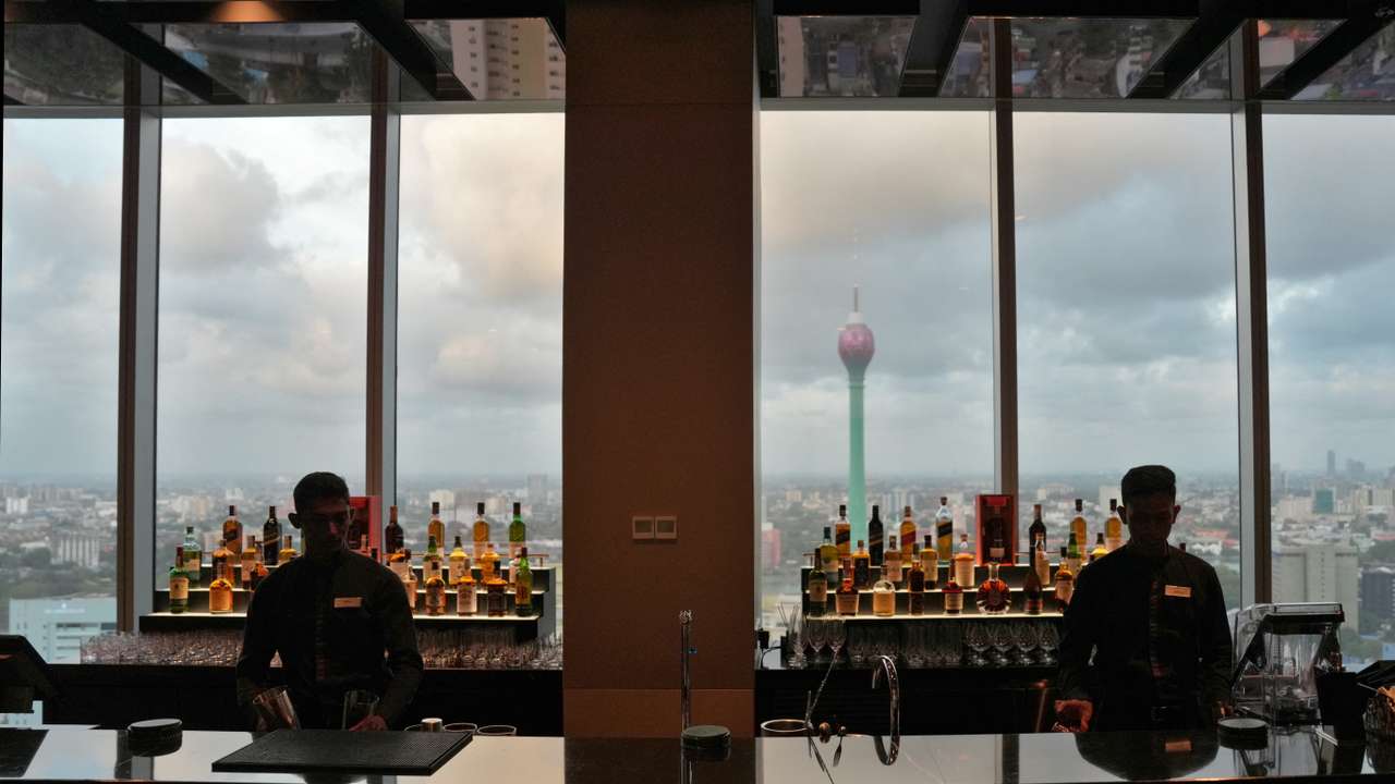 Employees work at a bar in the City of Dreams in Colombo