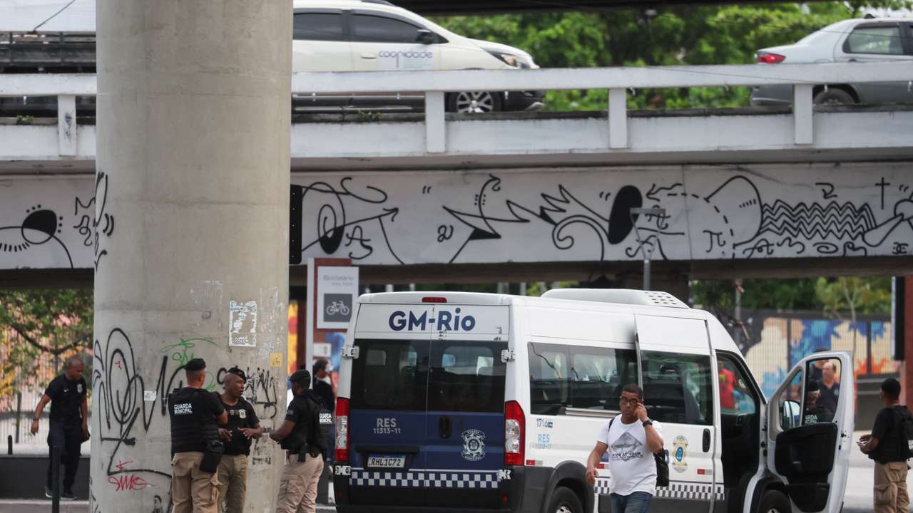 Municipal guards gather near the bus terminal station after a man hijacked a bus with passengers, in Rio de Janeiro