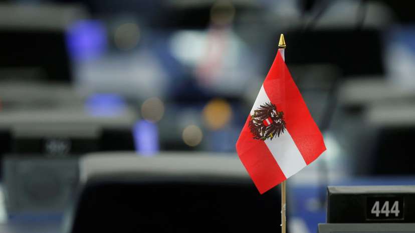 An Austrian flag is seen on the desk of a MEP during a debate at the European Parliament in Strasbourg
