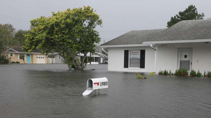 A mailbox whose door was forced open remains above flooding after Hurricane Milton passed in South Daytona