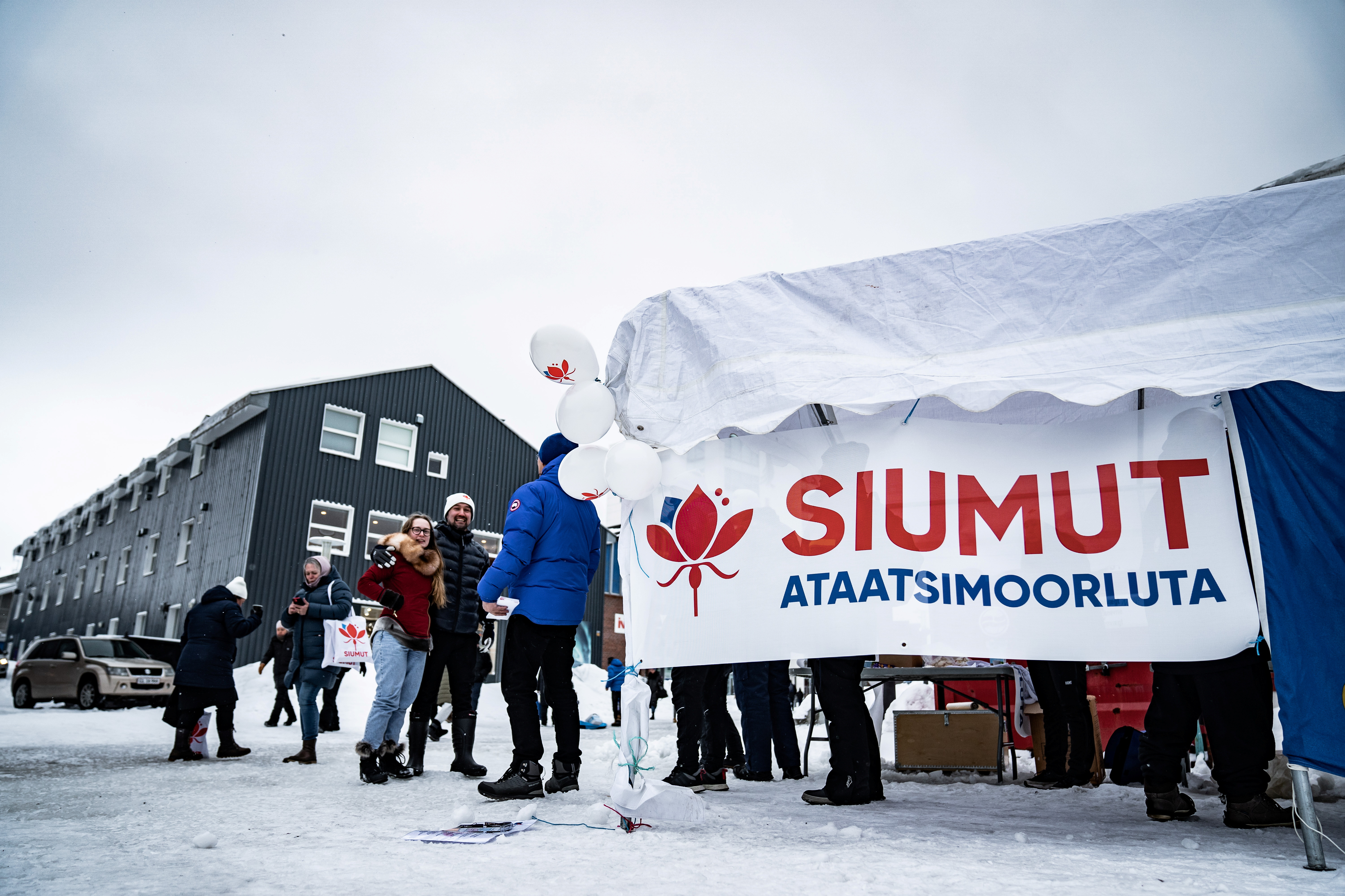 Candidates from the Greenlandic party Siumut pass out flyers in Nuuk