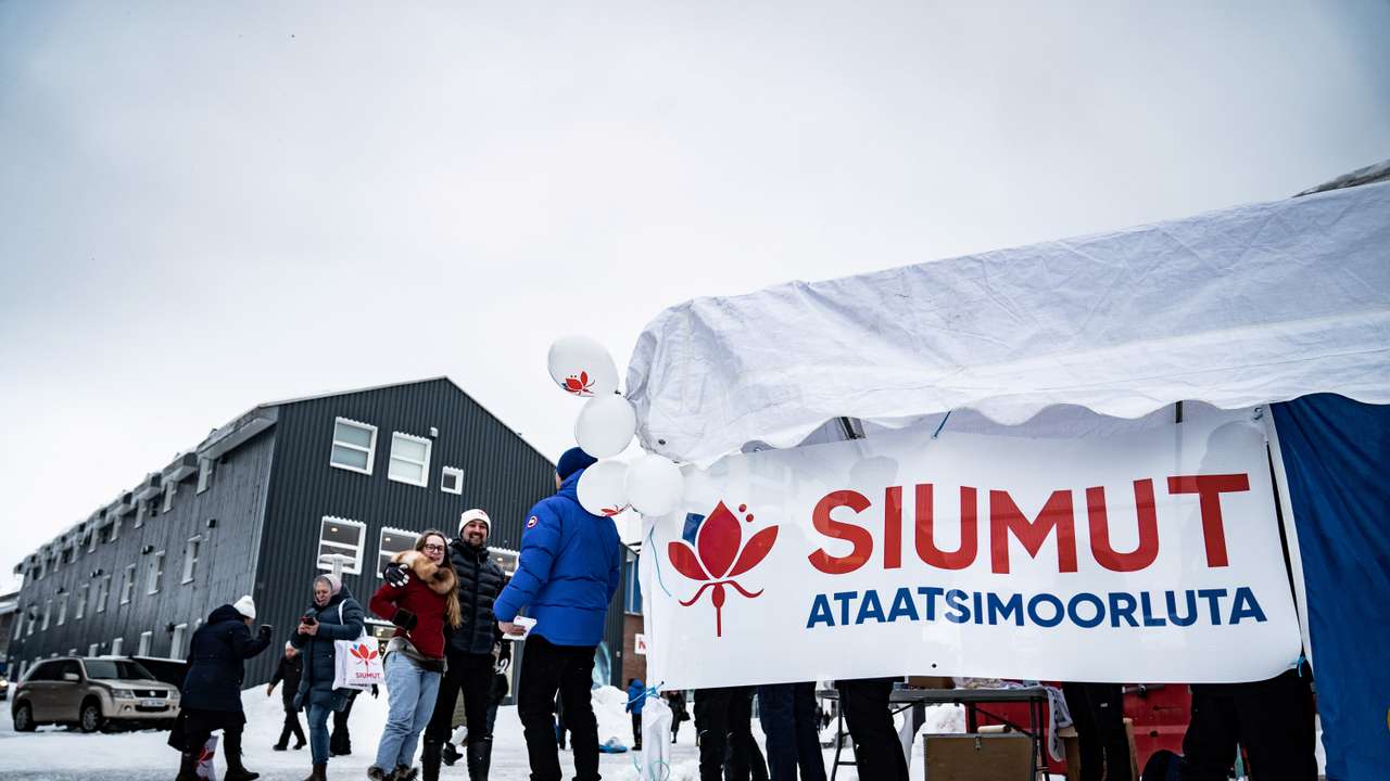 Candidates from the Greenlandic party Siumut pass out flyers in Nuuk