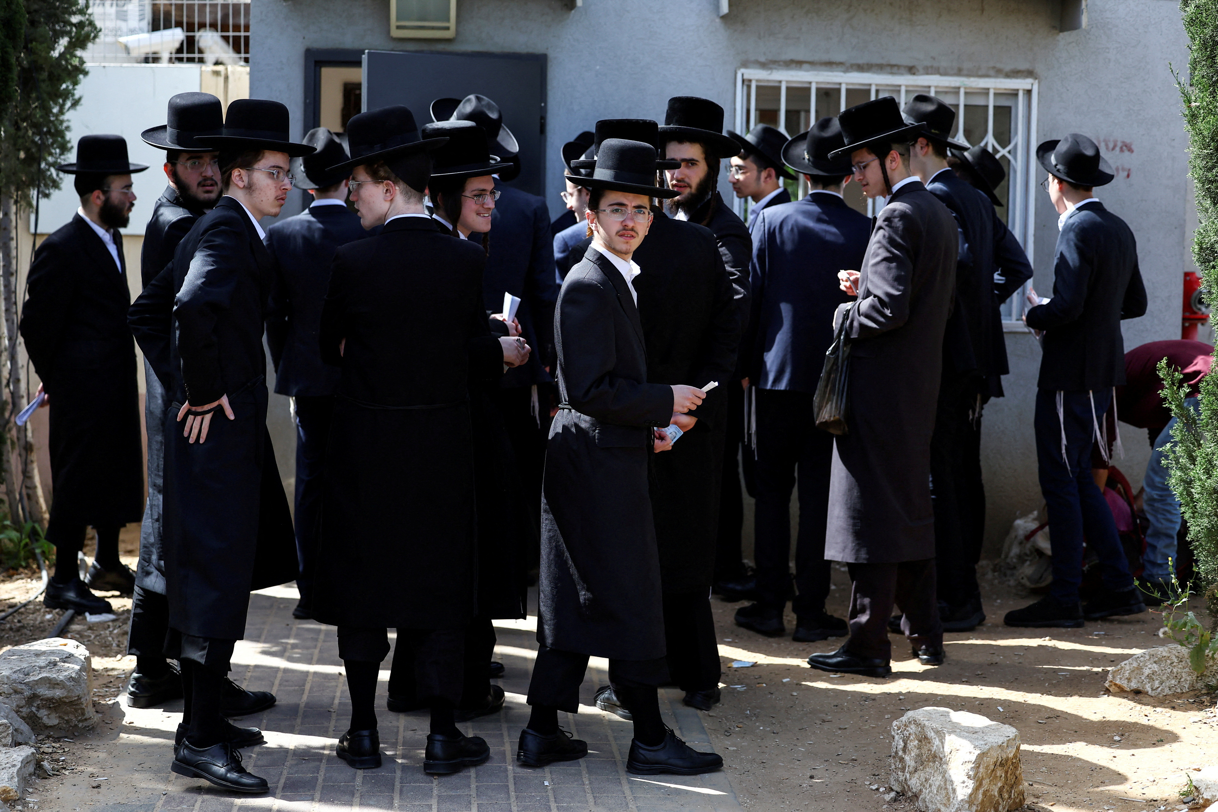FILE PHOTO: Ultra-Orthodox Jews line up at an Israeli draft office to process their exemptions from mandatory military service at a recruitment base in Kiryat Ono