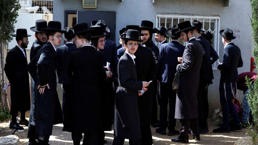 FILE PHOTO: Ultra-Orthodox Jews line up at an Israeli draft office to process their exemptions from mandatory military service at a recruitment base in Kiryat Ono
