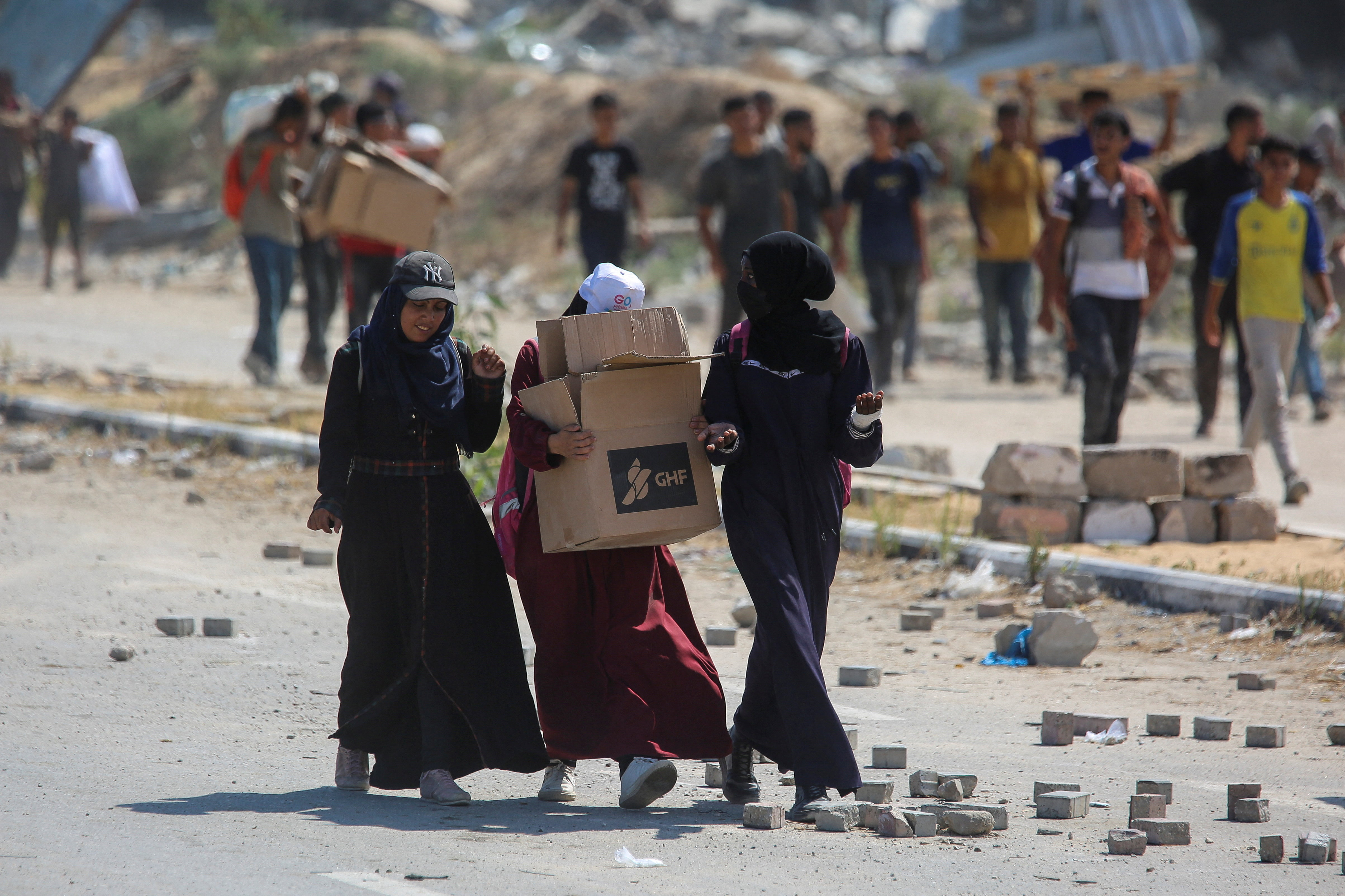 Palestinians seek aid supplies from the U.S.-backed Gaza Humanitarian Foundation (GHF), in the central Gaza Strip