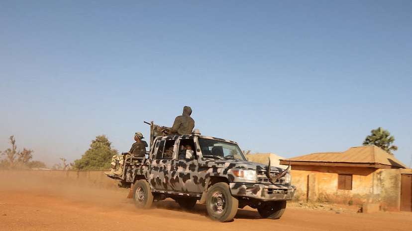 FILE PHOTO: Members of security forces ride a truck as they patrol in Kankara