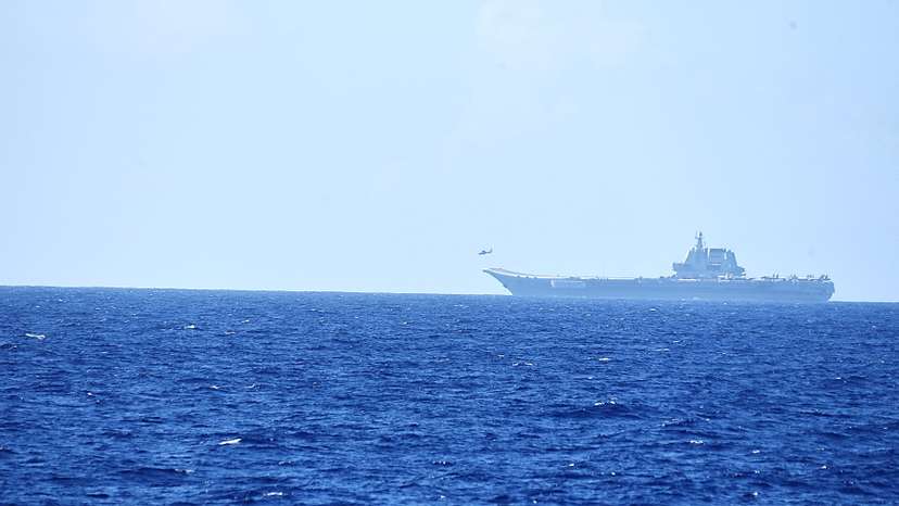 A helicopter takes off from China's Shandong aircraft carrier, over Pacific Ocean waters, south of Okinawa prefecture