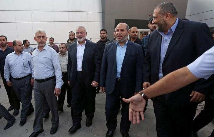Hamas Gaza Chief Yahya Al-Sinwar, Hamas Chief Ismail Haniyeh and senior Hamas leader Khalil al-Hayya arrive at the Rafah border crossing in the southern Gaza Strip