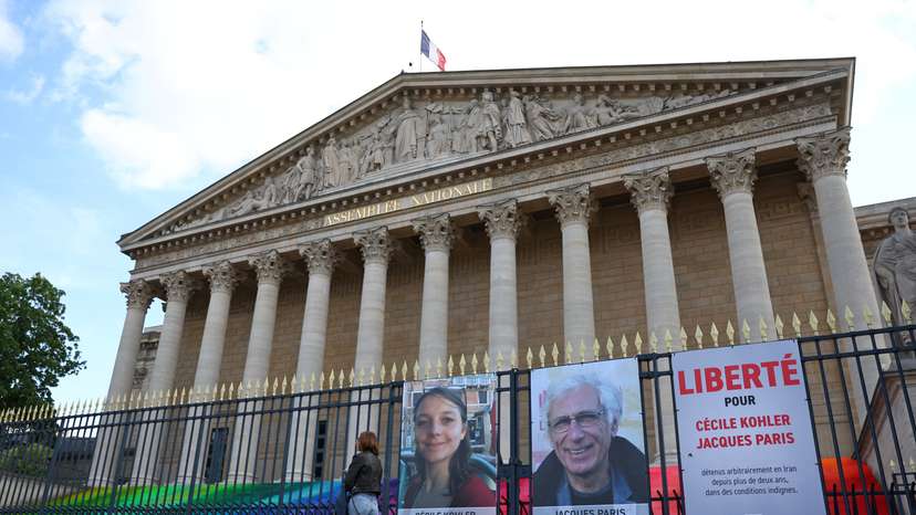 Posters of Cecile Kohler and Jacques Paris in front of the National Assembly in Paris