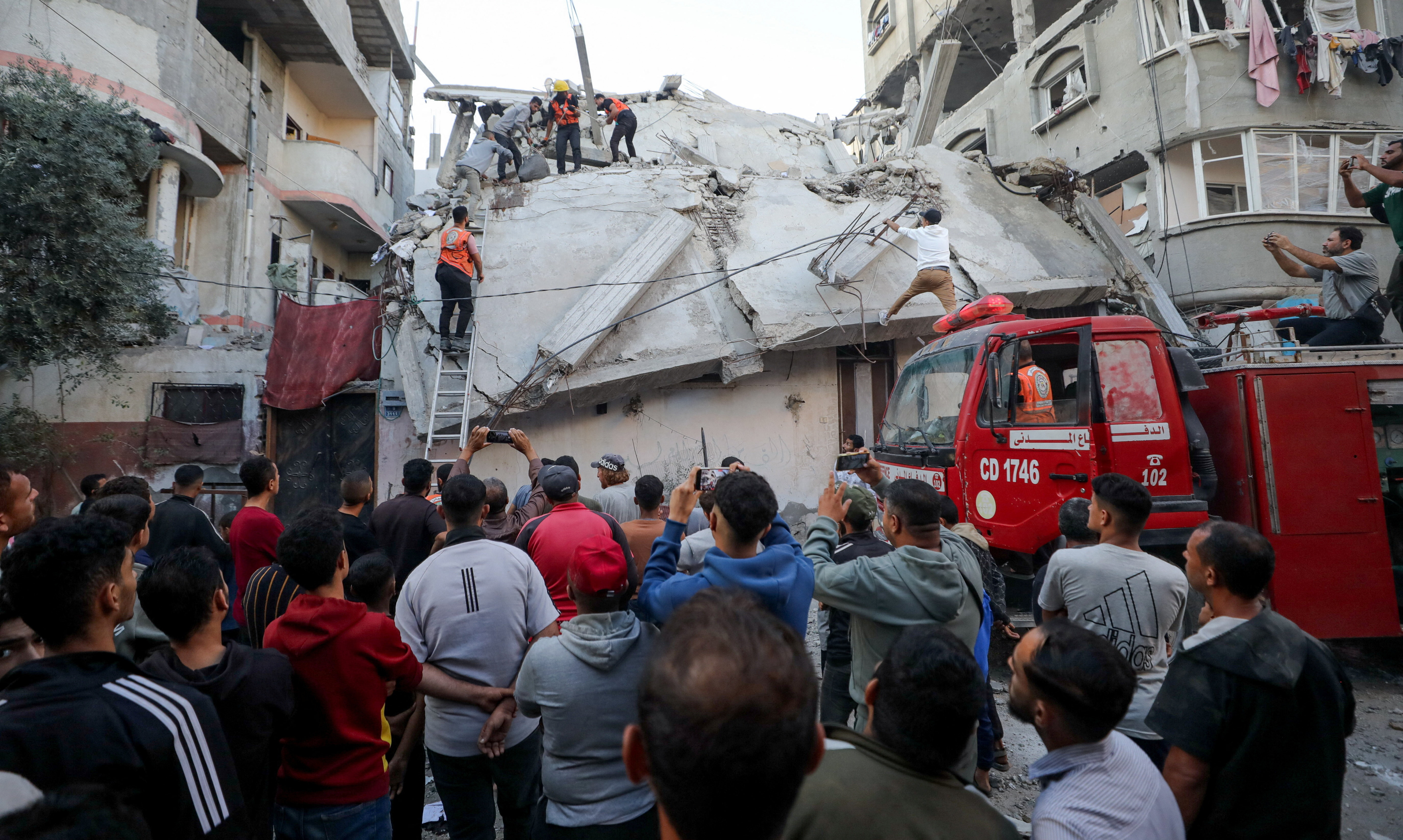 Palestinians inspect the site of an Israeli strike, in Gaza City